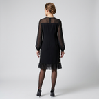 Black long sleeve shift dress, back view, sheer floral sleeves and layered ruffle hem