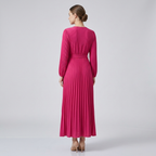 Women's hot pink long-sleeve pleated wrap maxi dress, back view with waist tie