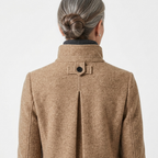 Back view of women’s stand-collar winter coat in tan fleece with buttoned collar