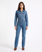 Women's blue denim jumpsuit with button-front, collar, long sleeves, straight legs