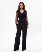 Black V-neck jumpsuit with sheer dotted sleeves and wide-leg pants