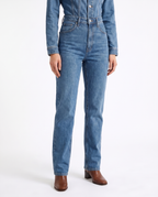 Women's blue denim jumpsuit with belted waist and straight ankle-length legs