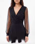 Black V-neck jumpsuit with sparkling sheer sleeves and structured waist
