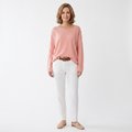 Light pink boat-neck knit sweater with long sleeves, relaxed draped fit