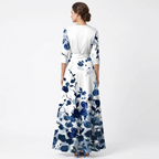 Women’s wrap maxi dress back view, white with blue floral print, V-neck, flowing long skirt