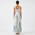 Back view of floral pleated maxi dress with blue and green botanical print, square neckline