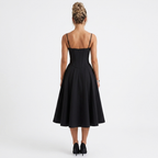 Black corset midi dress back view with spaghetti straps and flared skirt