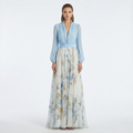 Light blue V-neck maxi dress with long balloon sleeves, smocked waist, blue floral skirt.