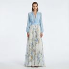Light blue V-neck maxi dress with long balloon sleeves, smocked waist, blue floral skirt.