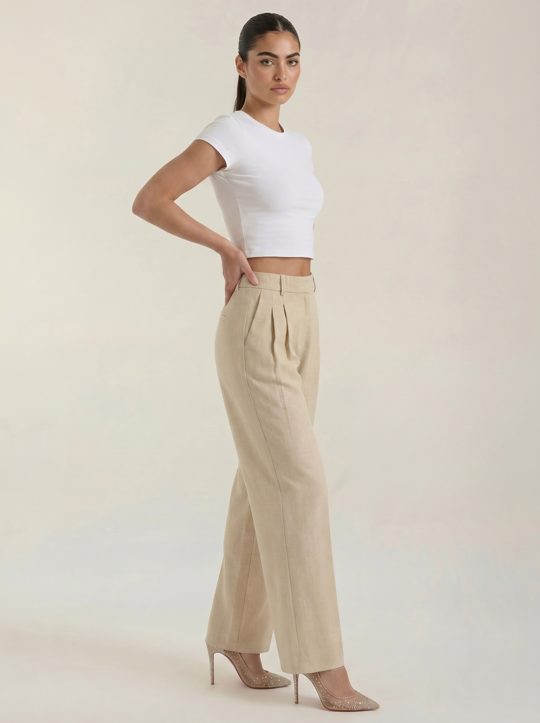 Pleated high-rise wide-leg pants in beige, relaxed fit with pleated front