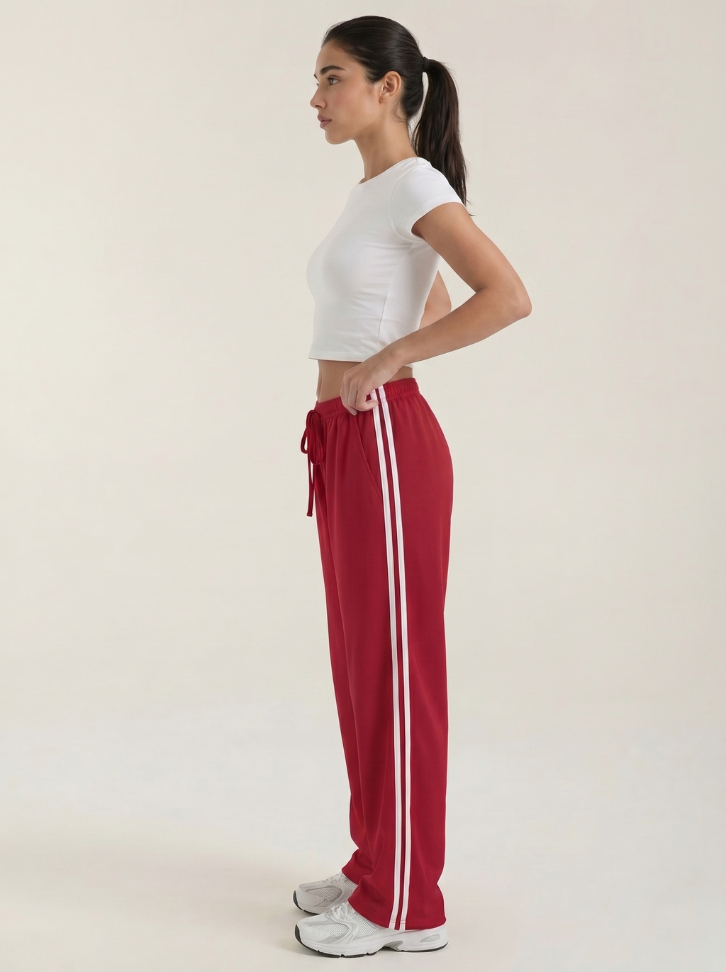 Red wide-leg track pants, side view, elastic waist with drawstring and stripe