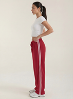 Red wide-leg track pants, side view, elastic waist with drawstring and stripe