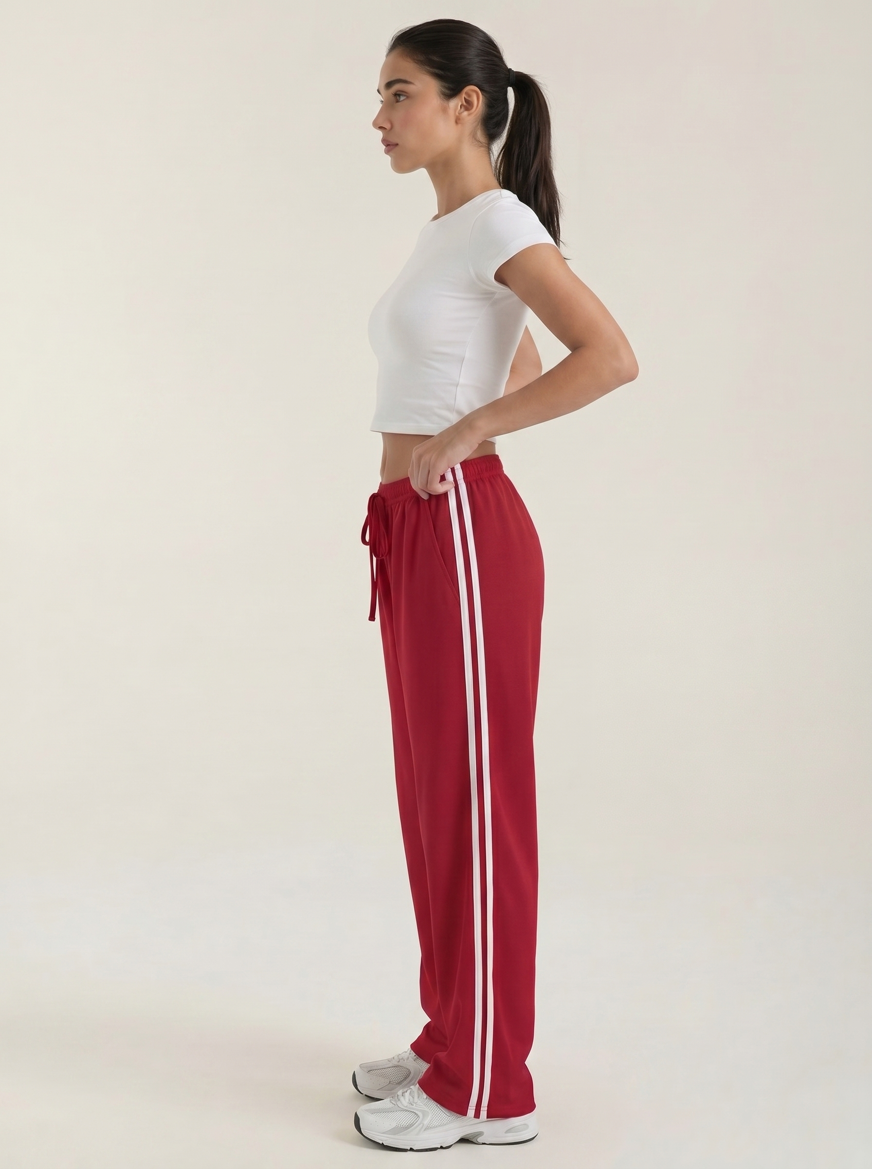 Red wide-leg track pants, side view, elastic waist with drawstring and stripe
