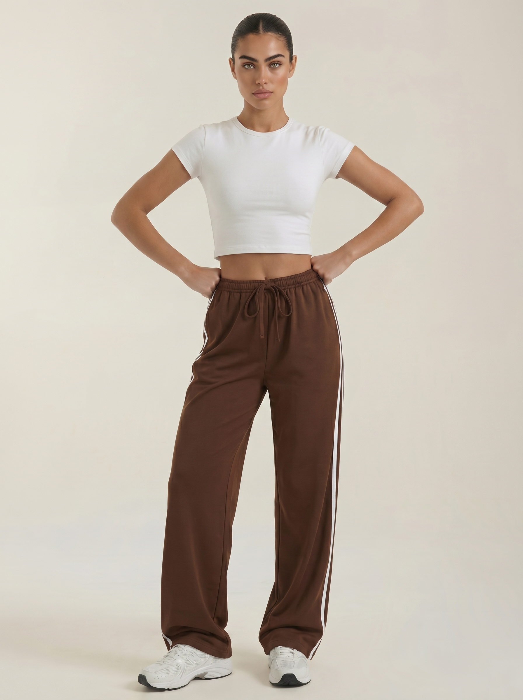 Brown wide-leg track pants with elastic waist, drawstring, and tapered open legs