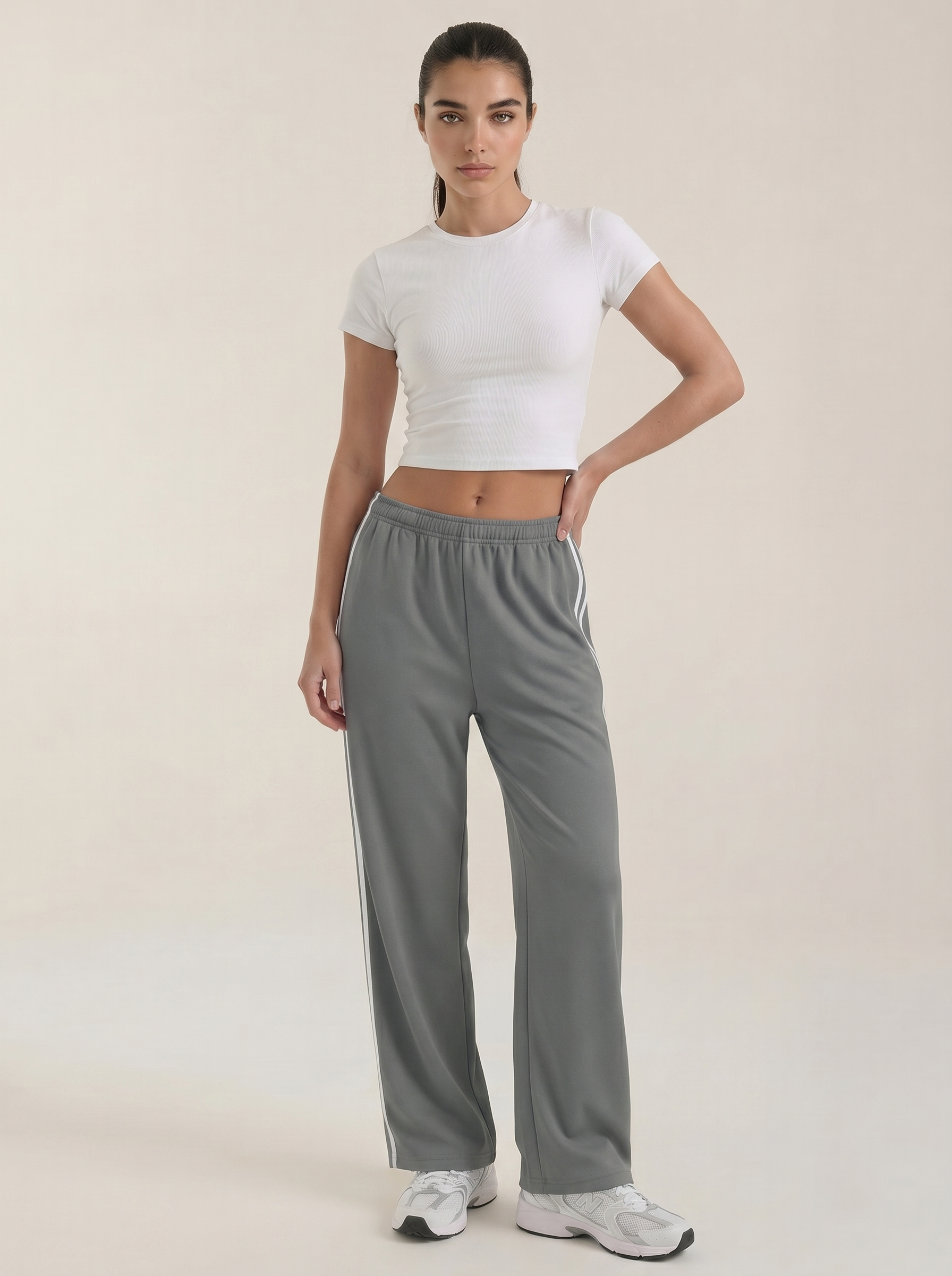 Women’s wide leg track pants in gray with white side stripe and elastic drawstring waist
