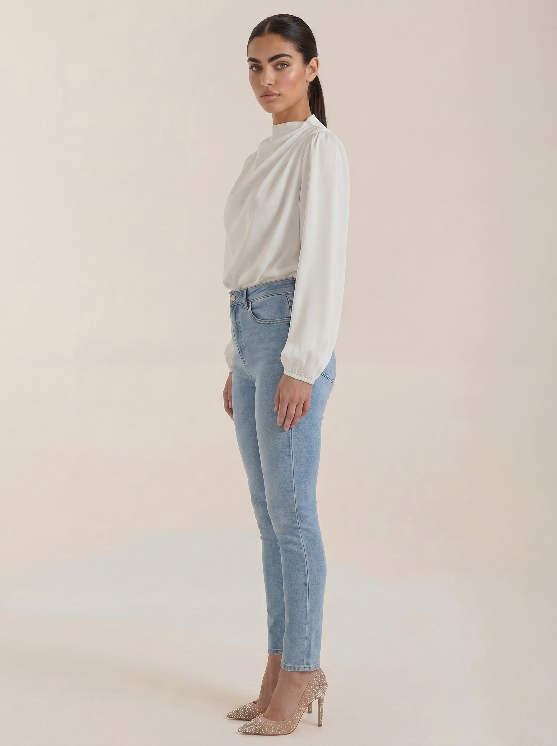 White draped long-sleeve blouse side view with cowl neckline and elastic cuffs