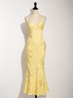 Yellow floral jacquard maxi dress on mannequin, corset-style bodice, spaghetti straps
