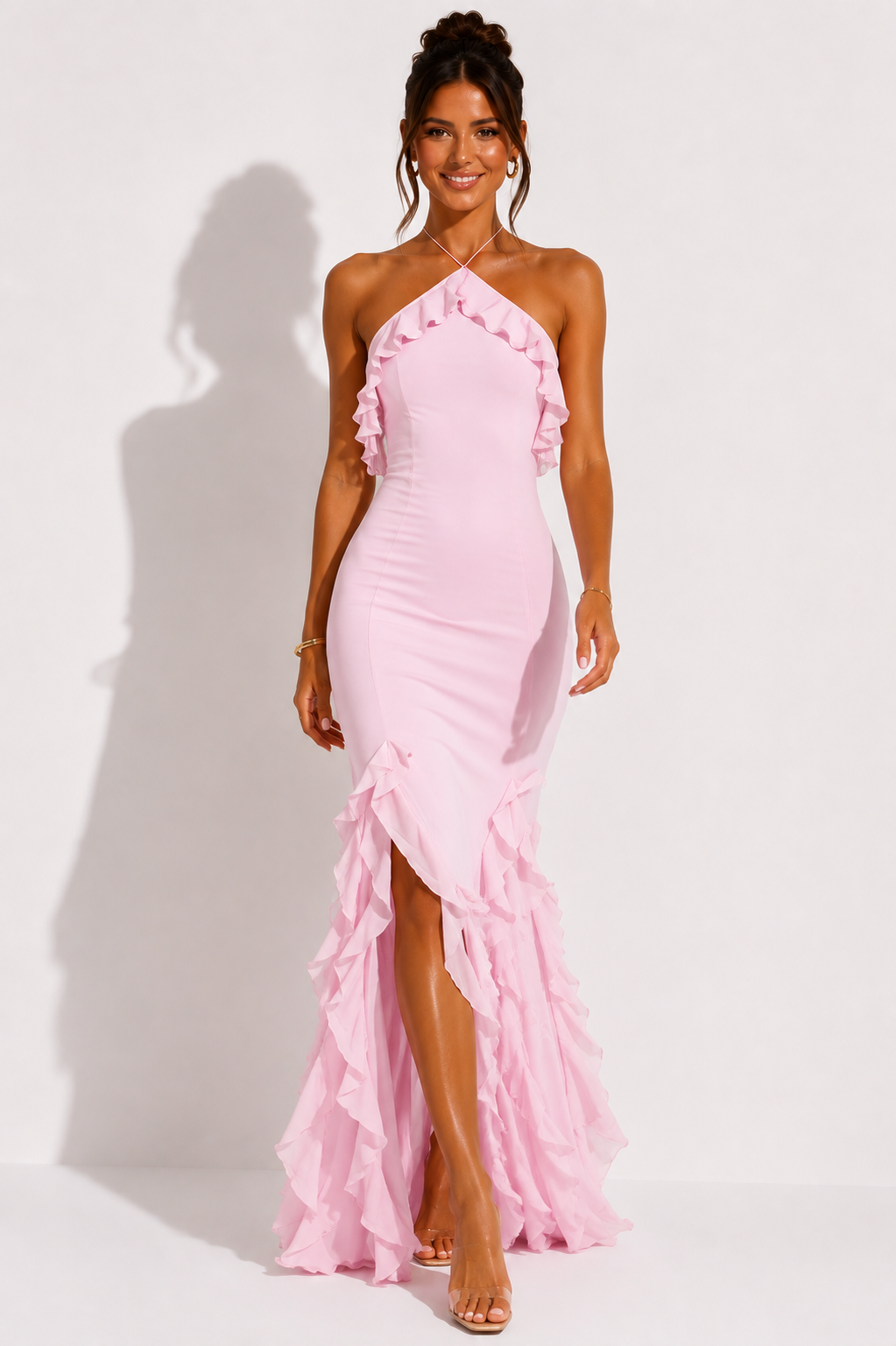 Pink halter-neck maxi dress with cascading ruffles along the skirt and long hem