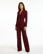 Burgundy V-neck blazer jumpsuit with belted waist and wide-leg legs