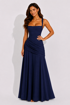 Navy maxi dress with square neckline and ruched draped waist, sleeveless, long skirt.