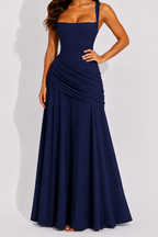 Navy ruched maxi dress with square neckline and draped waist, sleeveless, long skirt.