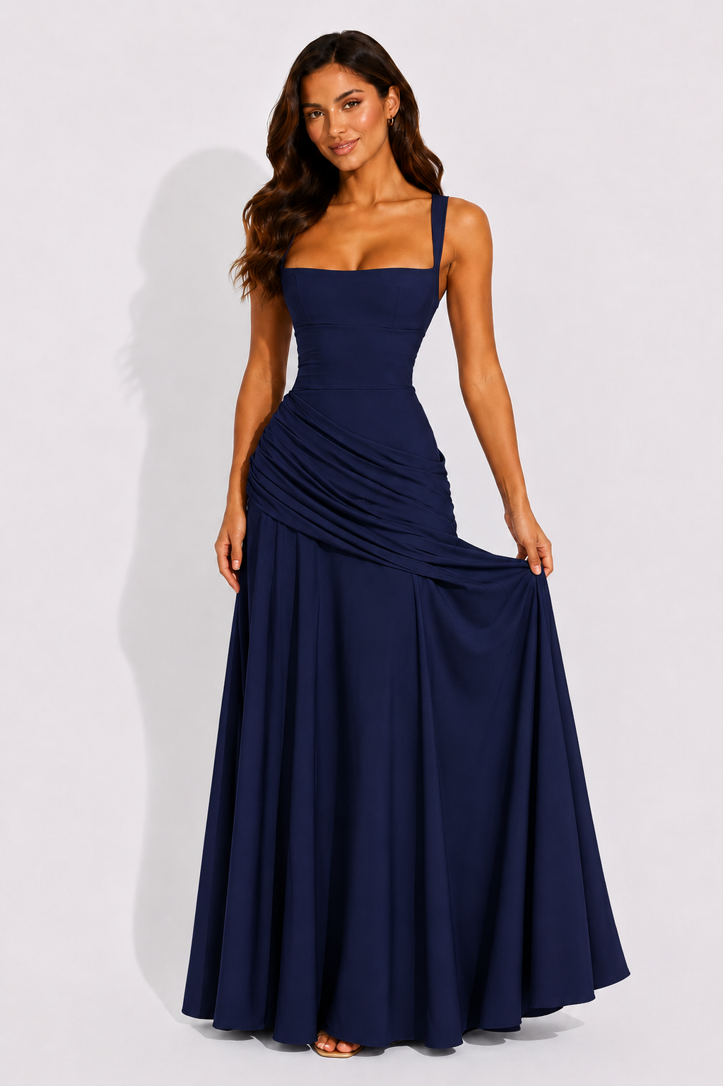Navy square-neck maxi dress with draped waist and soft pleats, sleeveless.