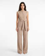 Beige sleeveless wide-leg jumpsuit with tied waist belt and zip-front, straight-on