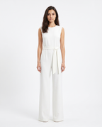 White sleeveless wide-leg jumpsuit with tie-waist sash and high neckline